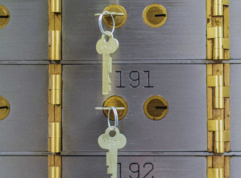 Two metal mailbox doors with brass hardware and keys hanging from keyholes, numbered 191 and 192